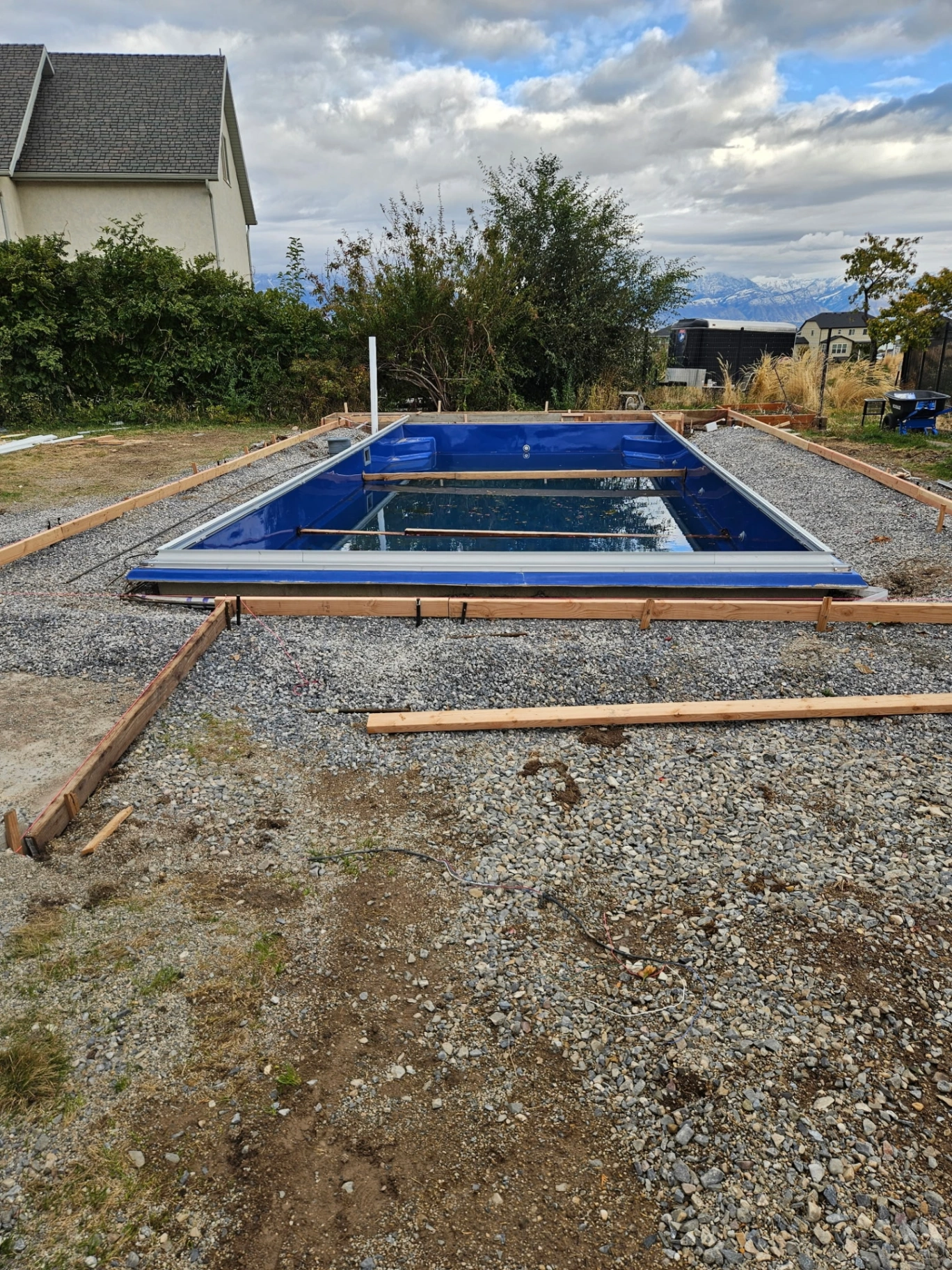 Step 1 — Fiberglass shell set on gravel base, leveled and partially filled for stability