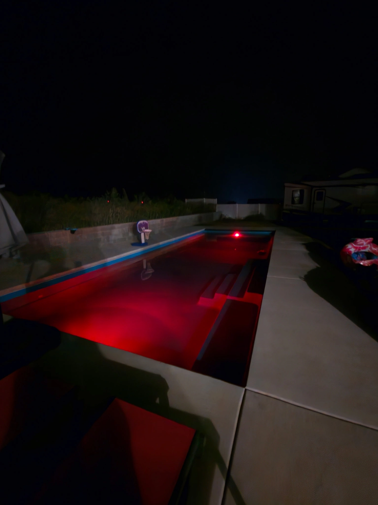 Pool bathed in red LED lighting for a dramatic nighttime look