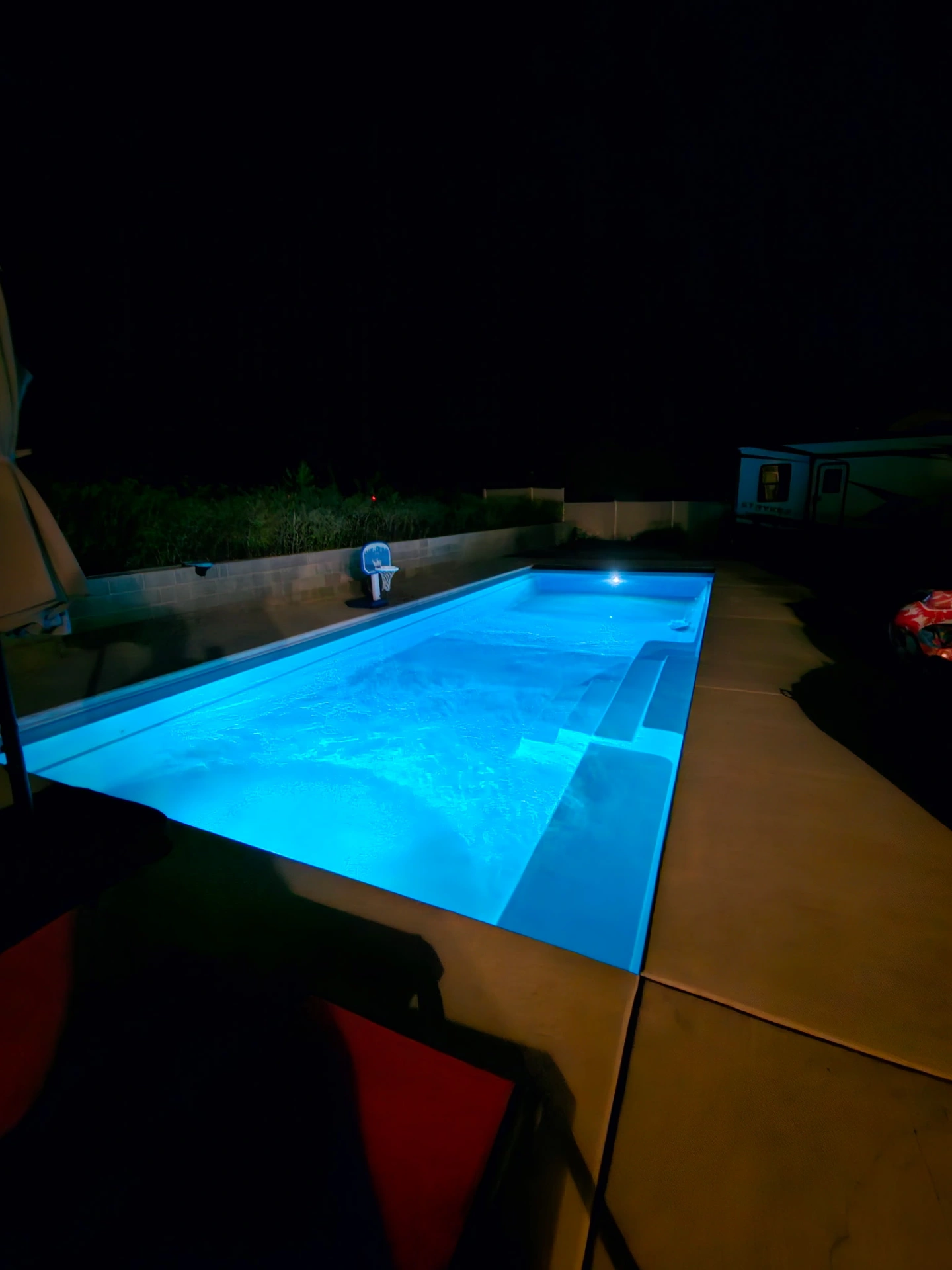 Pool lit with bright white LED lighting at night