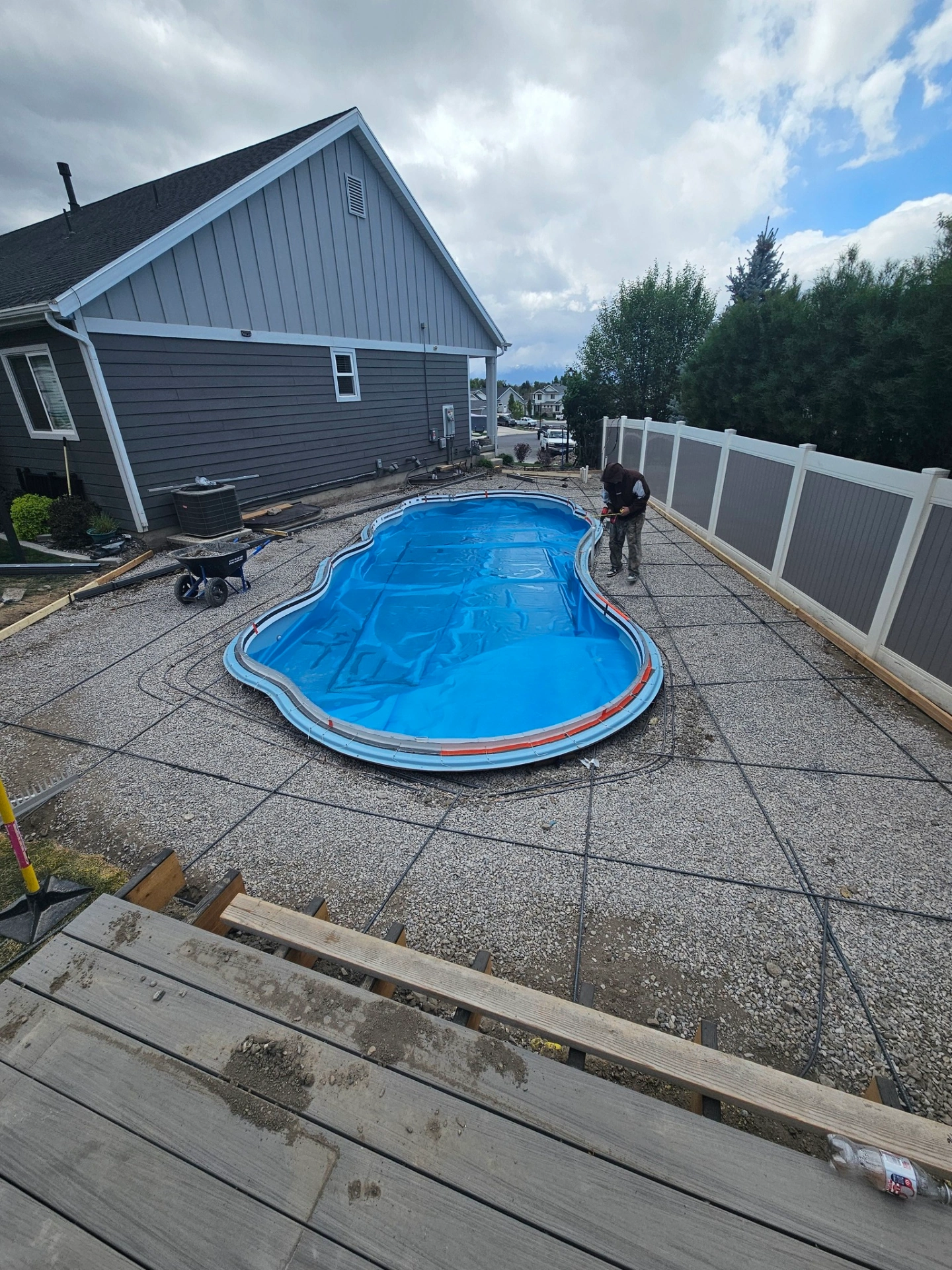 Pool deck rebar grid tied around fiberglass shell prior to concrete pour